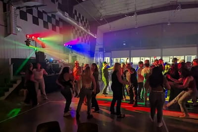 Guests dancing under colorful lighting at a Manitoba social event